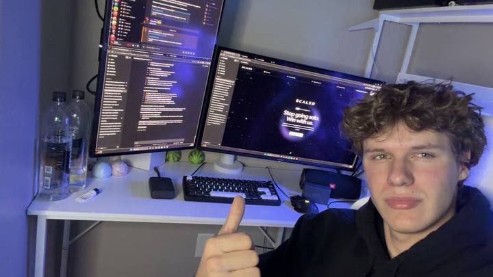 Logan at his desk, giving a thumbs up next to the Scaled site